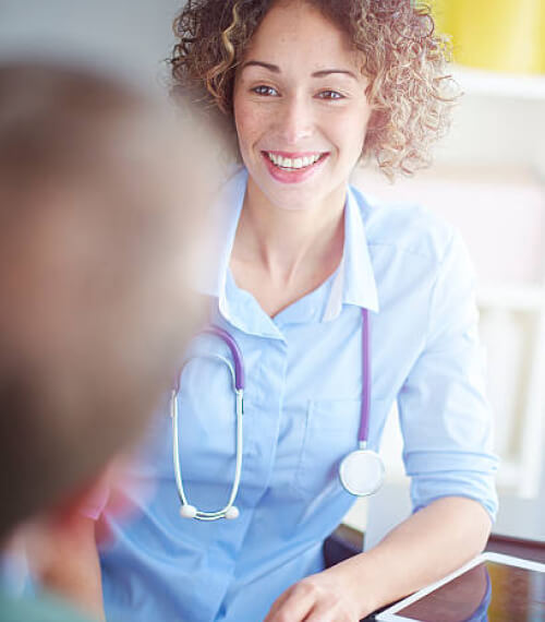 Image of a lady doctor talking to her patient