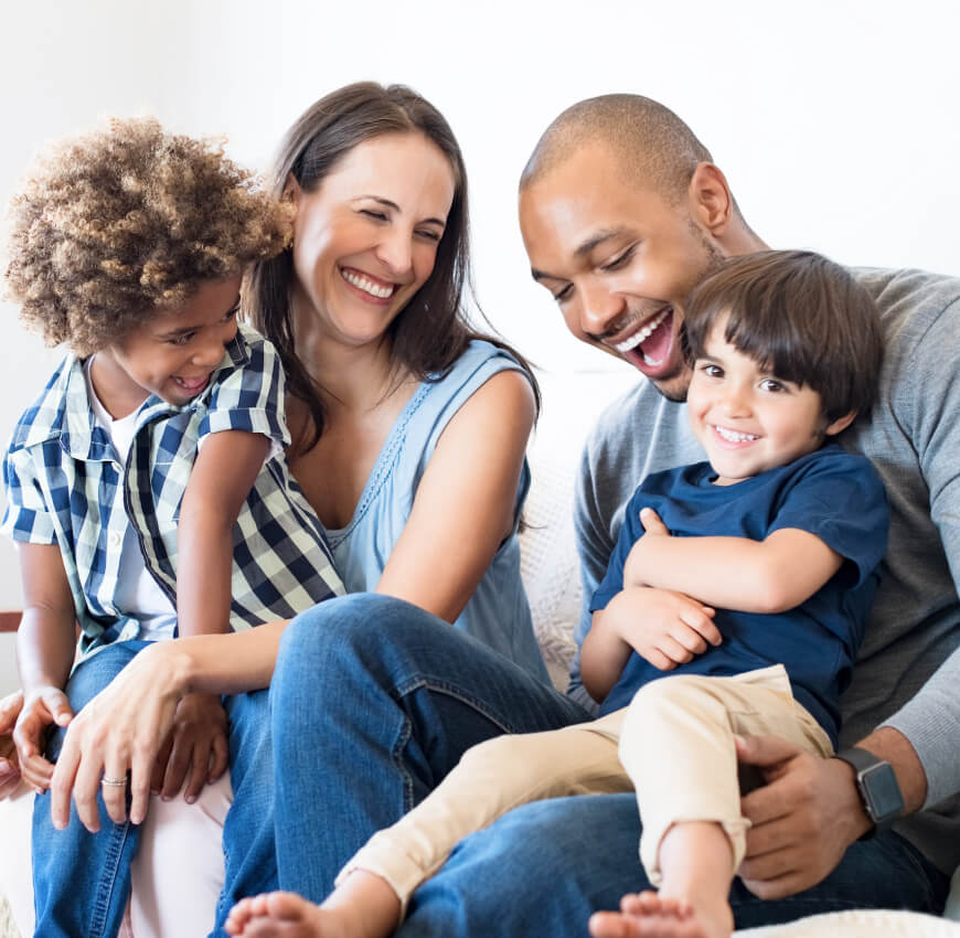 Image of a smiling family, mother, father and two children