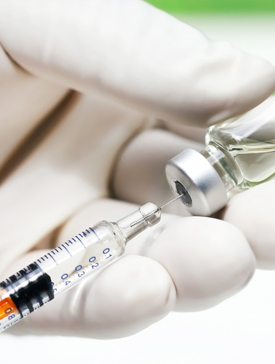 Image of a vaccine holding by two hands of a doctor