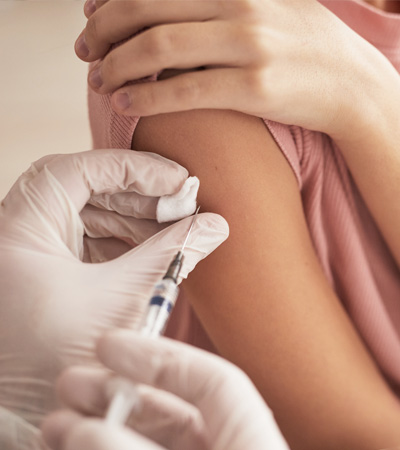 Doctor giving a vaccine to a female patient