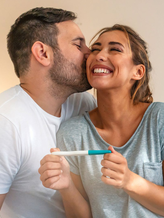 An happy and smiling couple and the man kissing his woman